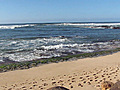 Tourists and residents watch North Shore Surf