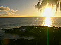 Royalty Free Stock Video SD Footage Zoom Out From Man Walking on Rocks to Sunset on Beach in Kauai,  Hawaii