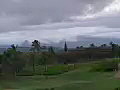 Royalty Free Stock Video SD Footage Pan Left to Storm Clouds,  Mountains,  Palm Trees and Golf Course in Kauai, Hawaii