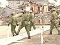 Japanese rescuers search through rubble at airport