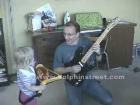 Kid and Dad Jamming on the Guitar