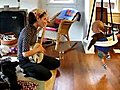 Baby dances to mother’s banjo playing.