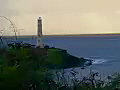 Royalty Free Stock Video SD Footage Static Shot of Light Beacon as Light Flashes at Sunrise on Beach in Kauai,  Hawaii