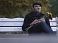 Man on park bench waiting for a rendezvous,  looking around