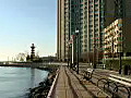 Royalty Free Stock Video HD Footage Pan Up From Boardwalk,  Buildings and American Flag in Jersey City, New Jersey