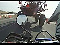 Biker Drives Under Tractor