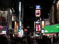 Royalty Free Stock Video HD Footage Zoom Out to Flashing Lights of Times Square in New York City at Night