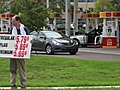 Conceptual artist plays as gas price sign