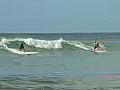 Royalty Free Stock Video HD Footage Surfer Rides a Wave at Waikiki Beach in Honolulu,  Hawaii