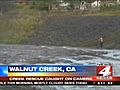 Car flips into cold and choppy creek