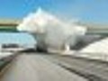 Snow-laden truck strikes bridge