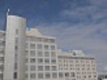 Hospital with timelapse clouds. Wide.