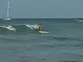 Royalty Free Stock Video HD Footage Female Surfer Rides a Wave at Waikiki Beach in Honolulu,  Hawaii
