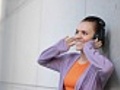 Attractive woman with headphones outdoor,  tracking shot