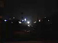 Royalty Free Stock Video HD Footage Night View of a Railroad Crossing and Train in the Distance