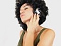 Woman with afro listening to music,  isolated, slow motion