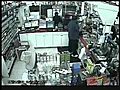 Surveillance video shows robbery of convenience store in progress