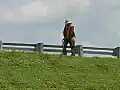 Royalty Free Stock Video HD Footage Worker Mowing Grass on an Expressway Bridge