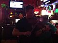 Firefighter Seamus Murphy plays the fiddle at Maguire’s