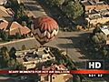 Hot air balloon crashes into building