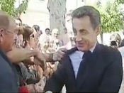Sarkozy grabbed and nearly knocked over