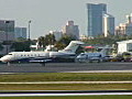 Royalty Free Stock Video HD Footage Private Business Jet Aircraft Taxis at the Airport with the City Skyline in the Background at Fort Lauderdale,  Florida