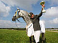 Woman Equestrian Celebrating with Trophy in Hand