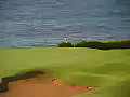 Royalty Free Stock Video SD Footage Zoom Out From Sand Trap to Mountains,  Palm Trees and Golf Course in Kauai, Hawaii