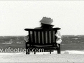 WOMAN IN DECK CHAIR BY THE OCEAN - HD