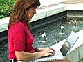 Female Typing By Fountain Stock Footage