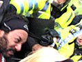 Police grab spitting protester