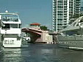 Royalty Free Stock Video HD Footage Draw Bridge Opens as a Mega Yacht Passes by on the New River in Downtown Ft. Lauderdale,  Florida