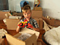 HD: Boy Unpacking Toys In New Home