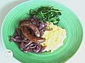 Sausages and mash with spinach,  red wine and onion gravy