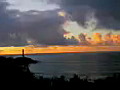 Royalty Free Stock Video SD Footage Light Beacon Flashes Light at Sunrise on Beach in Kauai,  Hawaii