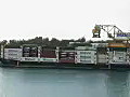 Royalty Free Stock Video HD Footage Tug Boat Passes by a Container Cargo Ship at the Port of Honolulu,  Hawaii
