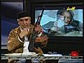 Libyan newsreader brandishes gun on TV show