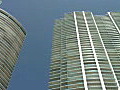 Royalty Free Stock Video HD Footage Pan Left to High Rise Condos and Office Buildings with Bright Sun in Downtown Miami,  Florida