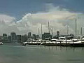 Royalty Free Stock Video HD Footage Small Boat Arrives at a Marina with City Skyline on Key Biscayne in Miami,  Florida