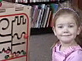 Royalty Free Stock Video HD Footage Child Playing With Beads Toy in a Library on a Winters Day