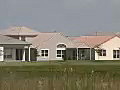 Royalty Free Stock Video SD Footage Pan Left to Single Family Homes in the DIstance on a Sunny Day in Ft. Lauderdale,  Florida