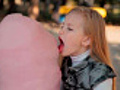 girl eating cotton candy