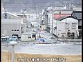 Moment of impact--head on ground view of tsunami rushing toward cameraman