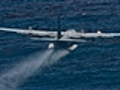 U.S. Air Force C-130 drops an oil-dispersing chemical on the spill