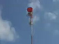 Royalty Free Stock Video HD Footage Communications Tower and Clouds Passing By in South Florida