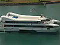 Royalty Free Stock Video HD Footage Small Cruise Ship Approaches the Port of Honolulu and Aloha Tower in Hawaii