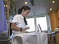 Royalty Free Stock Video SD Footage Crew Member Ironing on a Large Yacht Docked on the Intracoastal Waterway in Ft. Lauderdale,  Florida