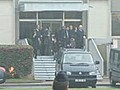 Coffins being carried into the vehicle