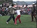 Men,  women, and children exchange blows in end of year ritual in Peru