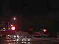 Royalty Free Stock Video HD Footage Night View of a Railroad Crossing and Cars in the Distance